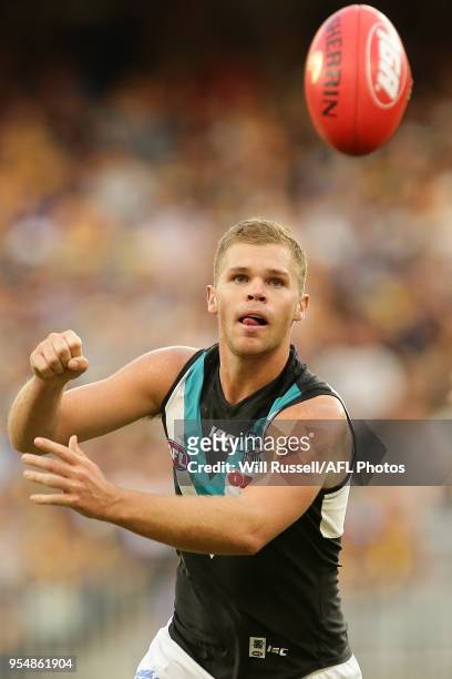 Dan Houston of the Power handpasses the ball during the round seven AFL match between the West Coast Eagles and the Port Adelaide Power at Optus...