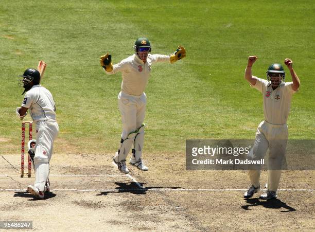 Brad Haddin and Simon Katich of Australia celebrate the dismissal of Mohammad Yousuf of Pakistan off the bowling of Nathan Hauritz during day five of...