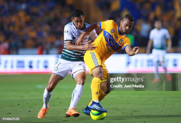 Jesus Isijara of Santos and Rafael De Souza of Tigres fight for the ball during the quarter finals first leg match between Tigres UANL and Santos...