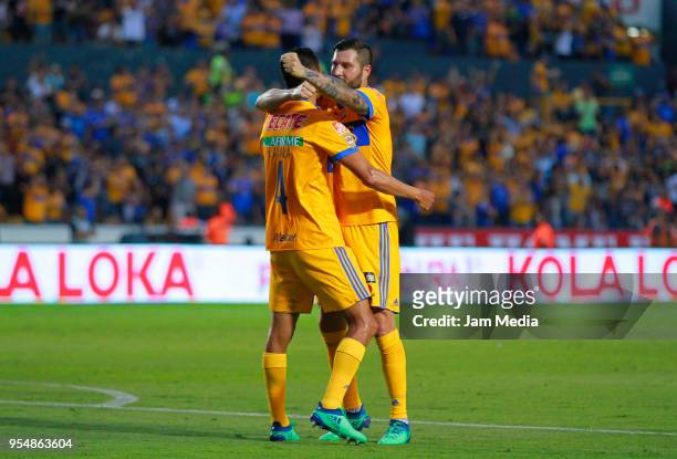 Hugo Ayala of Tigres celebrates with teammate Andre-Pierre Gignac after scoring the first goal of his team during the quarter finals first leg match...