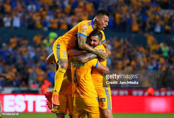 Hugo Ayala of Tigres celebrates with teammates Andre-Pierre Gignac and Eduardo Vargas after scoring the first goal of his team during the quarter...