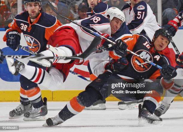 Umberger of the Columbus Blue Jackets is flipped by Richard Park of the New York Islanders at the Nassau Coliseum on December 29, 2009 in Uniondale,...