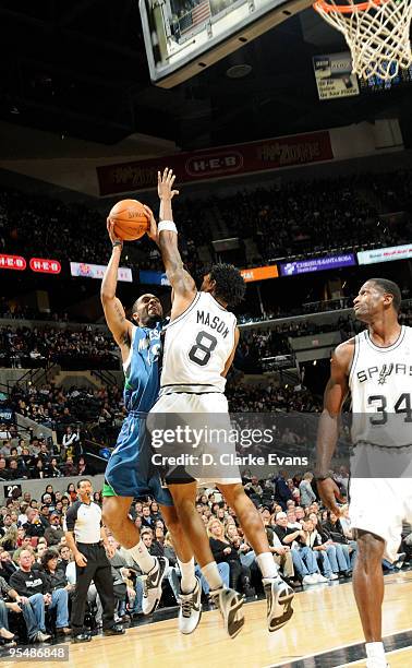 Wayne Ellington of the Minnesota Timberwolves shoots against Roger Mason, Jr. #8 of the San Antonio Spurs on December 29, 2009 at the AT&T Center in...