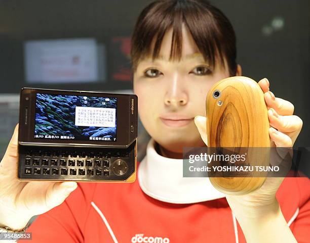 Lifestyle-Japan-telecom-mobile,FEATURE, by Frank Zeller An employee of Japanese mobile communication giant NTT docomo displays a prototype model of...