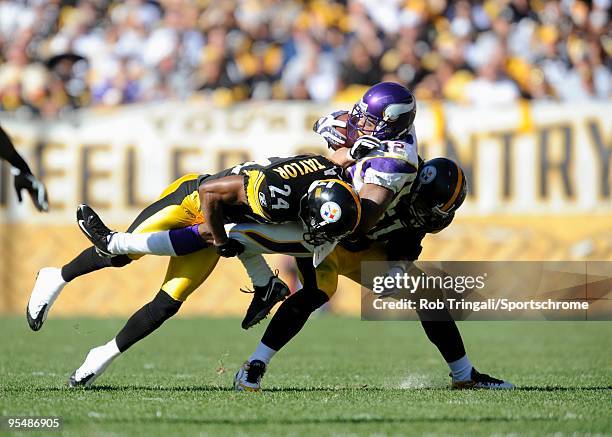 Percy Harvin of the Minnesota Vikings is tackled by Ike Taylor and James Farrior of the Pittsburgh Steelers at Heinz Field on October 25, 2009 in...