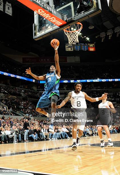 Damien Wilkins of the Minnesota Timberwolves shoots against Roger Mason, Jr. #8 of the San Antonio Spurs on December 29, 2009 at the AT&T Center in...