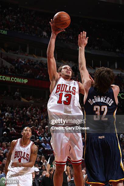 Joakim Noah of the Chicago Bulls shoots a jumpshot against Josh McRoberts of the Indiana Pacers on December 29, 2009 at the United Center in Chicago,...