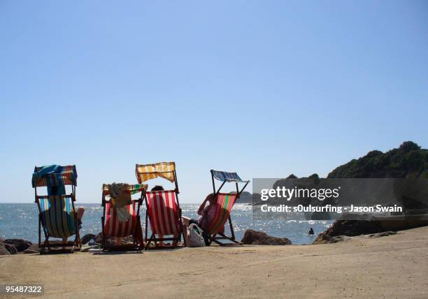 deck chairs on beach - s0ulsurfing stock-fotos und bilder