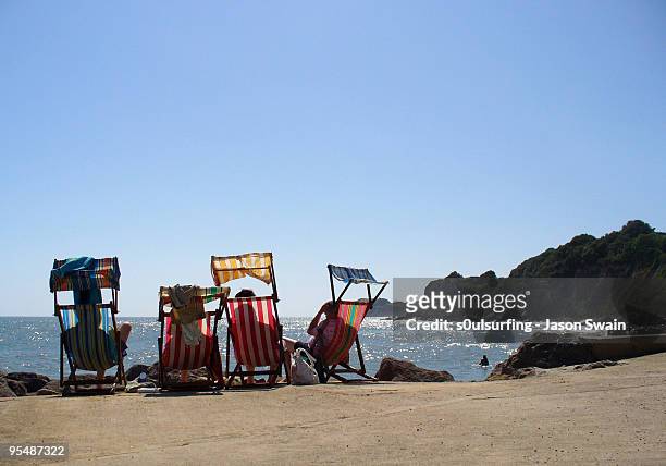 deck chairs on beach - s0ulsurfing stock pictures, royalty-free photos & images