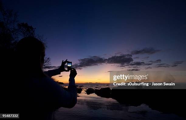 camera phone sunset - totland bay stock pictures, royalty-free photos & images