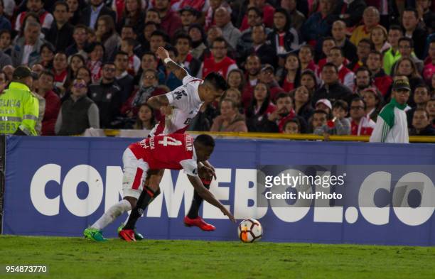 John Pajoy of Independiente Santa Fe vies for the ball with the player of River Plate during a group stage match between Independiente Santa Fe and...