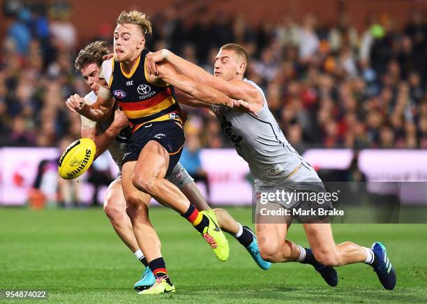 Hugh Greenwood of the Adelaide Crows breaks away from Liam Jones of the Blues during the round seven AFL match between the Adelaide Crows and the...