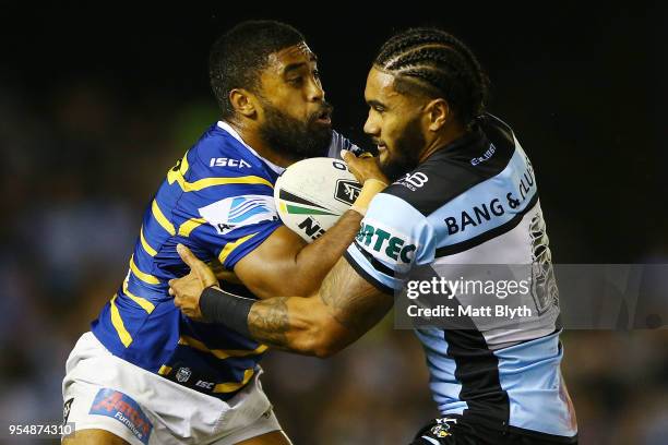 Michael Jennings of the Eels is tackled by Ricky Leutele of the Sharks during the round nine NRL match between the Cronulla Sharks and the Parramatta...