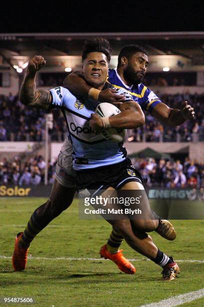 Sosaia Feki of the Sharks is tackled by Michael Jennings of the Eels during the round nine NRL match between the Cronulla Sharks and the Parramatta...