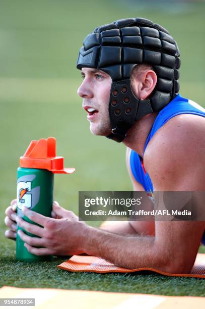 Caleb Daniel of the Bulldogs is seen on the interchange bench during the 2018 AFL round seven match between the Western Bulldogs and the Gold Coast...