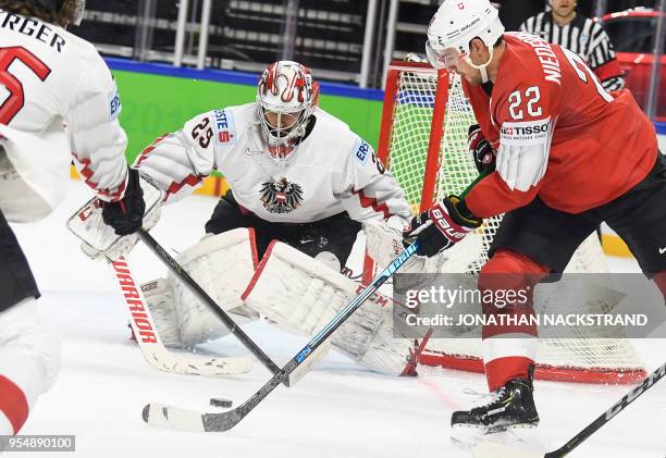 Switzerland's Nino Niederreiter strikes in front of Austria's goalie Bernhard Starkbaum during the group A match Switzerland vs Austria of the 2018...