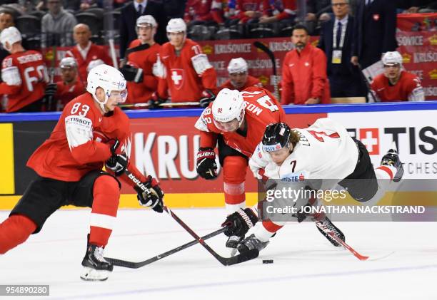 Austria's Brian Lebler vies with Switzerland's Simon Moser and Switzerland's Joel Vermin during the group A match Switzerland vs Austria of the 2018...