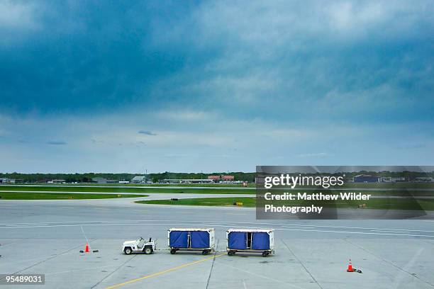 baggage cart on tarmac - airport tarmac stock pictures, royalty-free photos & images
