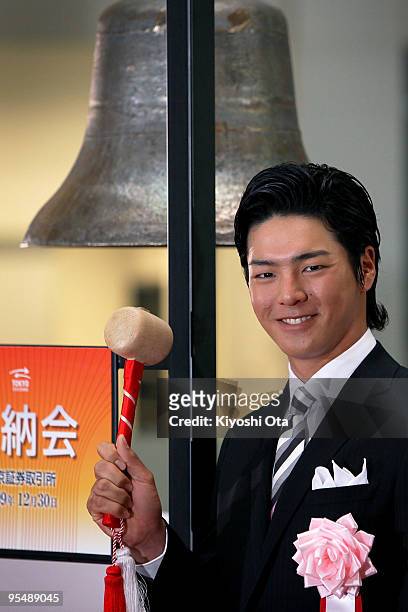 Golfer Ryo Ishikawa poses before ringing a bell during the closing ceremony to mark the end of the year's trading at the Tokyo Stock Exchange on...