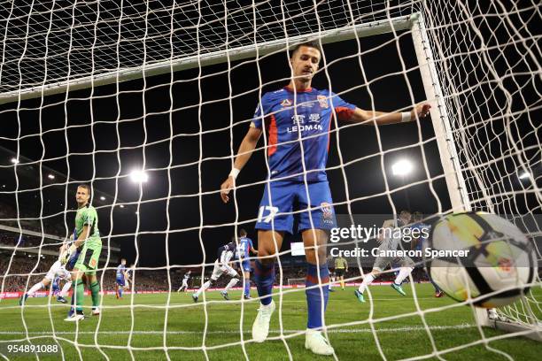 Kosta Barbarouses of the Victory scores a goal past goalkeeper Glen Moss of the Jets during the 2018 A-League Grand Final match between the Newcastle...