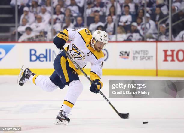 Roman Josi of the Nashville Predators shoots the puck down the ice during first period action against the Winnipeg Jets in Game Three of the Western...