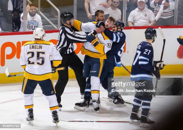Mark Scheifele of the Winnipeg Jets grabs a hold of Austin Watson of the Nashville Predators during a second period scrum in Game Three of the...