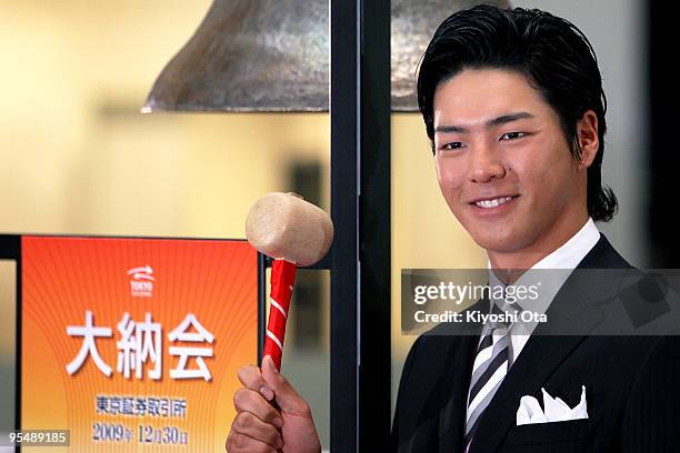 Golfer Ryo Ishikawa poses before ringing a bell to wish good luck for the market during the closing ceremony to mark the end of the year's trading at...