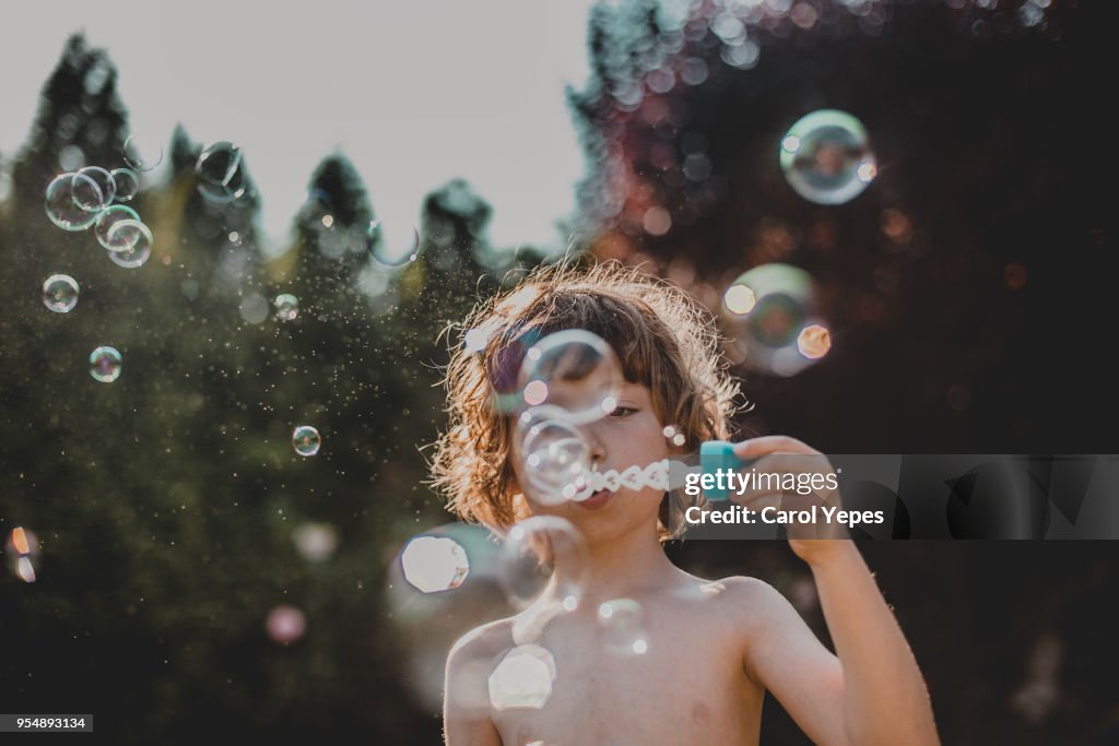 Boy making bubbles outdoor