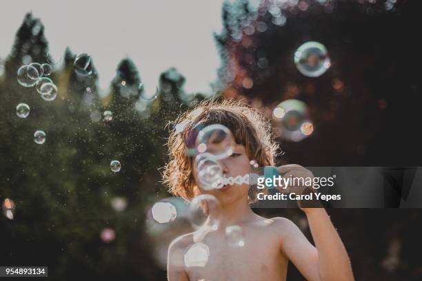 boy  making bubbles outdoor - player portraits stockfoto's en -beelden