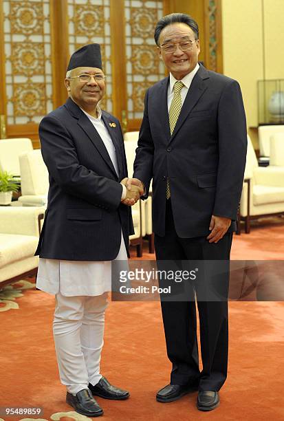 China's Chairman of the Standing Committee of the National People's Congress Wu Bangguo shakes hands with Nepal's Prime Minister Madhav Kumar Nepal...