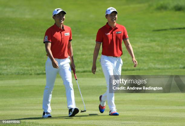 Soo Min Lee of South Korea speaks to Jeung Hun Wang of South Korea on the 6th hole during Day One of the GolfSixes at The Centurion Club on May 5,...