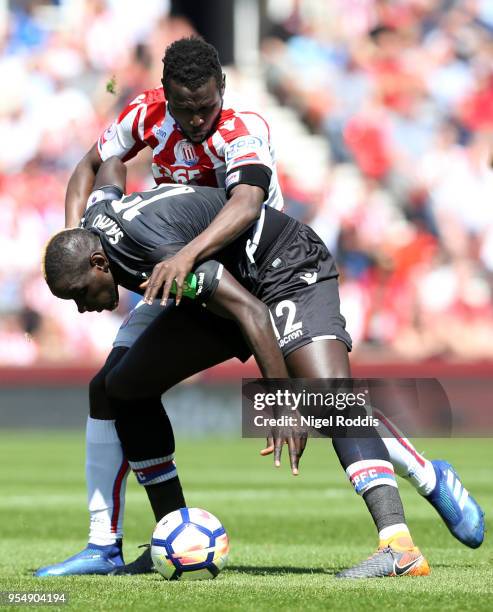 Mame Biram Diouf of Stoke City and Mamadou Sakho of Crystal Palace battle for the ball during the Premier League match between Stoke City and Crystal...