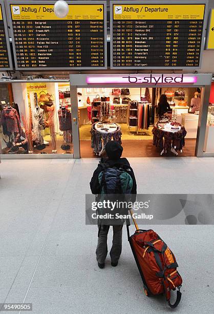 Traveller looks at a departures board at Tegel Airport on December 30, 2009 in Berlin, Germany. Germany has increased security measures in the past...