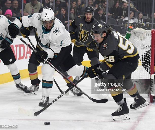 Evander Kane of the San Jose Sharks and Erik Haula of the Vegas Golden Knights go after a loose puck in the first period of Game Five of the Western...