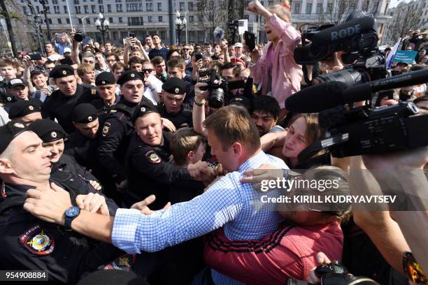 Russian riot police officers detain opposition leader Alexei Navalny during an unauthorized anti-Putin rally on May 5, 2018 in Moscow, two days ahead...