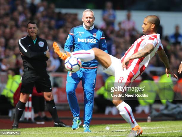 Paul Lambert, Manager of Stoke City looks on as Glen Johnson of Stoke City controls the ball during the Premier League match between Stoke City and...