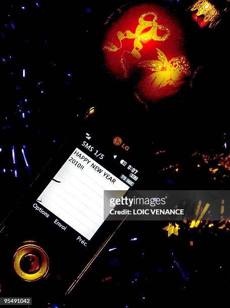 Picture taken on December 29, 2009 in Paris shows a SMS with the New Year greetings. More than 500 millions of SMSs should be sent in France on...