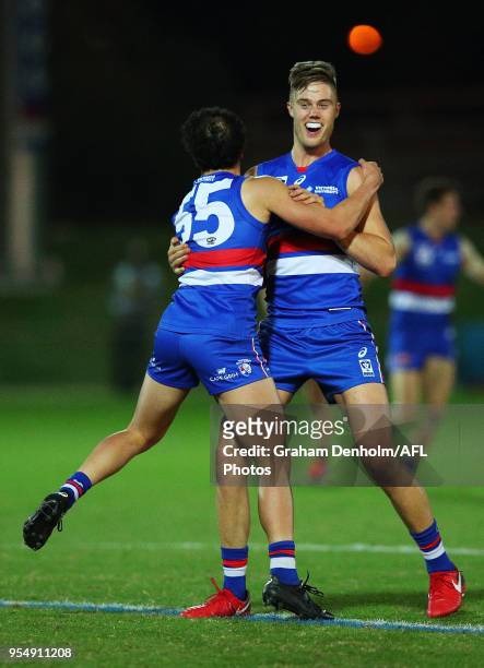 Joshua Schache of Footscray celebrates with teammate Alexander Greenwood after kicking the winning goal during the round five VFL match between...