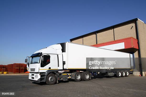semi truck at storage warehouse . - refrigerator truck stock pictures, royalty-free photos & images