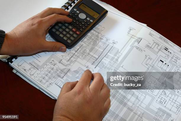 engineer calculating on diagram - electronic design engineer stock pictures, royalty-free photos & images