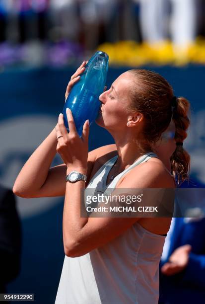 Petra Kvitova of the Czech Republic kisses the trophy after defeating Romania's Mihaela Buzarnescu in their final tennis match at the WTA Prague Open...