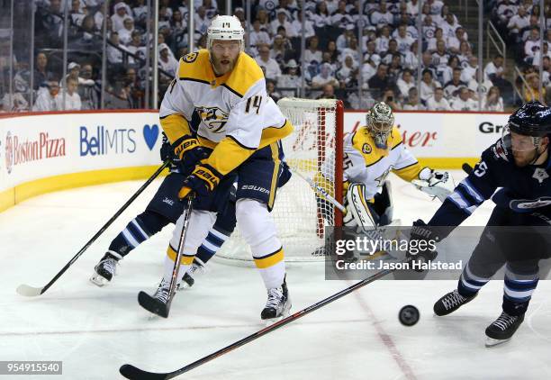 Mattias Ekholm of the Nashville Predators clears the puck under pressure from Paul Stastny of the Winnipeg Jets in Game Four of the Western...