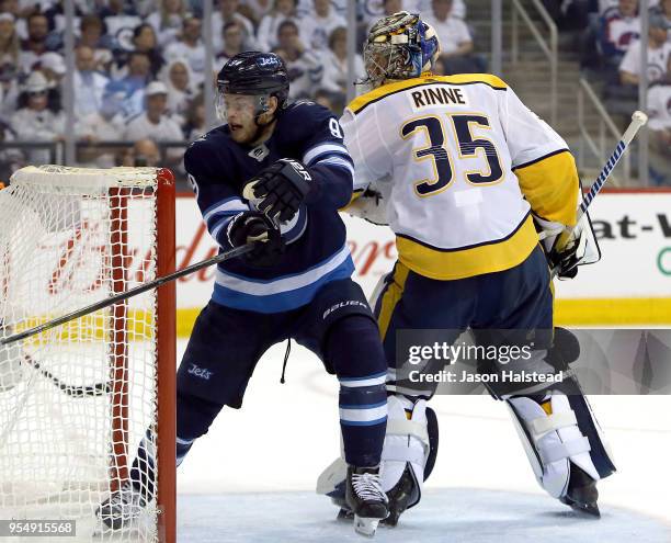 Andrew Copp of the Winnipeg Jets skates through the crease of Pekka Rinne of the Nashville Predators in Game Four of the Western Conference Second...