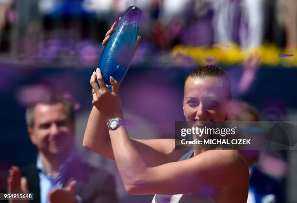 Petra Kvitova of the Czech Republic celebrates with the trophy after defeating Romania's Mihaela Buzarnescu in their final tennis match at the WTA...