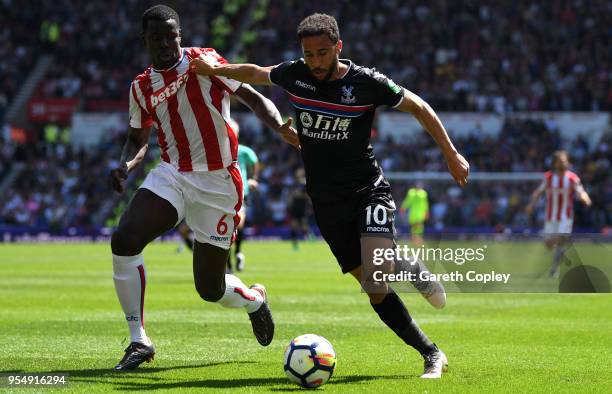 Kurt Zouma of Stoke City and Andros Townsend of Crystal Palace battle for possession during the Premier League match between Stoke City and Crystal...