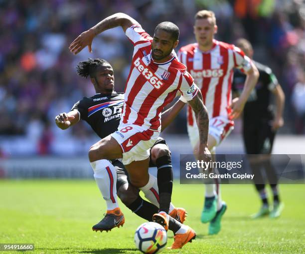 Wilfried Zaha of Crystal Palace tackles Glen Johnson of Stoke City during the Premier League match between Stoke City and Crystal Palace at Bet365...