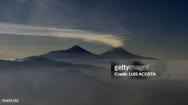 Picture of the Popocatepetl and Iztlacihuat volcanos, 120 km east of Mexico City, taken from an airplane on December 10, 2009. AFP PHOTO/Luis ACOSTA