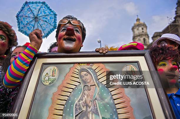 Mexican clowns hold the image of the Virgin of Guadalupe, Mexico's patron saint, in Mexico City on December 16, 2009. Hundreds of clowns arrived at...