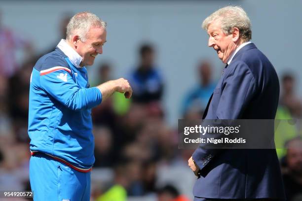 Paul Lambert, Manager of Stoke City speaks with Roy Hodgson, Manager of Crystal Palace during the Premier League match between Stoke City and Crystal...