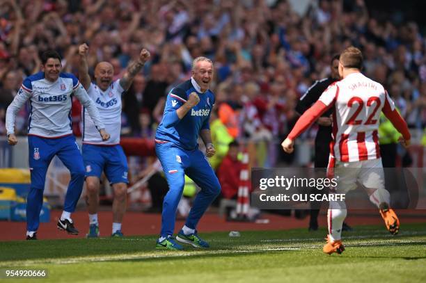 Stoke City's Swiss forward Xherdan Shaqiri celebrates scoring the opening goal with Stoke City's Scottish manager Paul Lambert during the English...